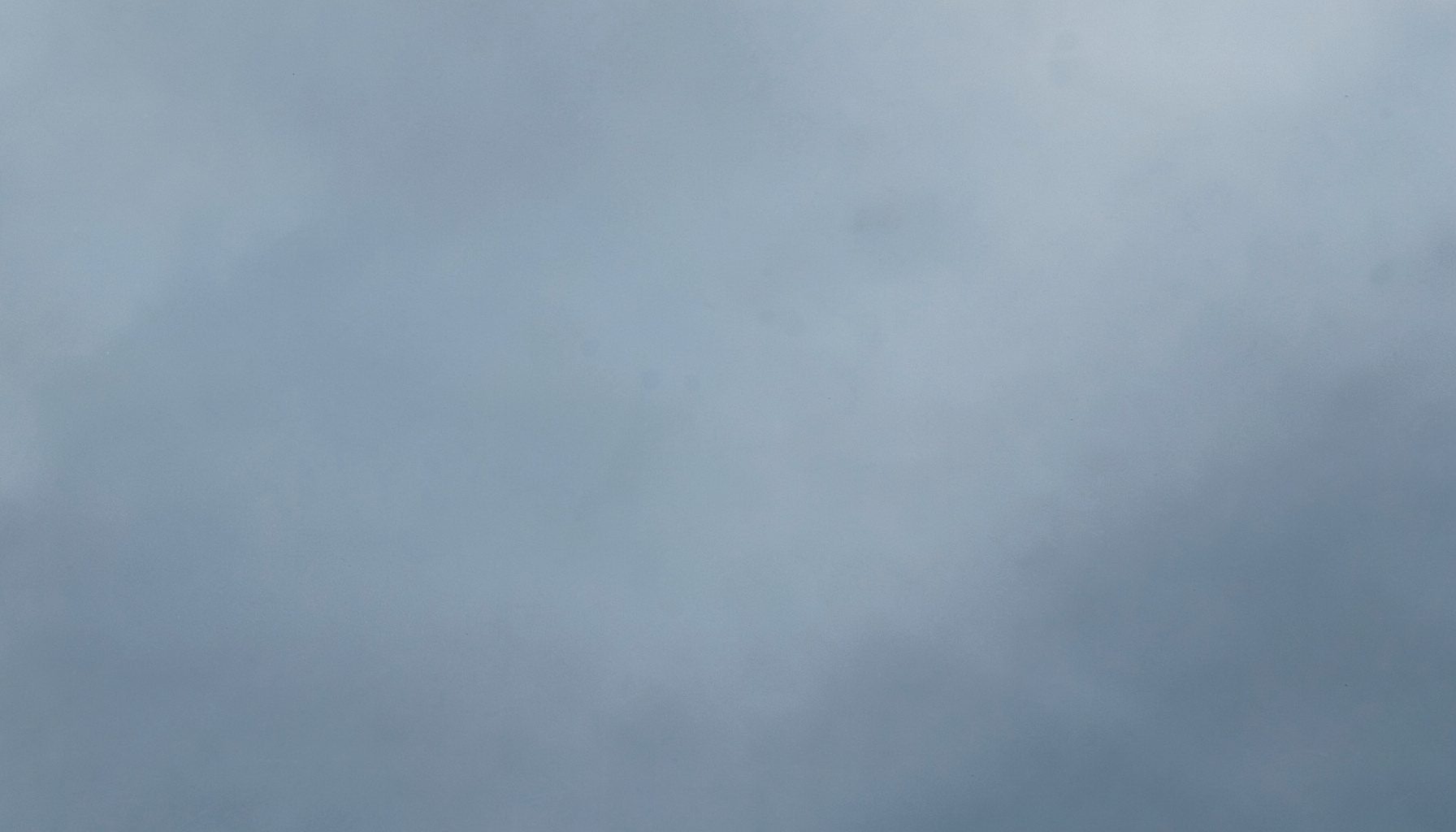 Muted blue-grey abstract texture with soft gradient, calm and editorial